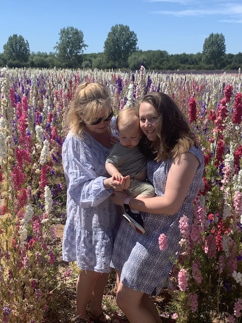 My mum, Rory and I in the confetti fields with Rory looking at a pink flower in my hand